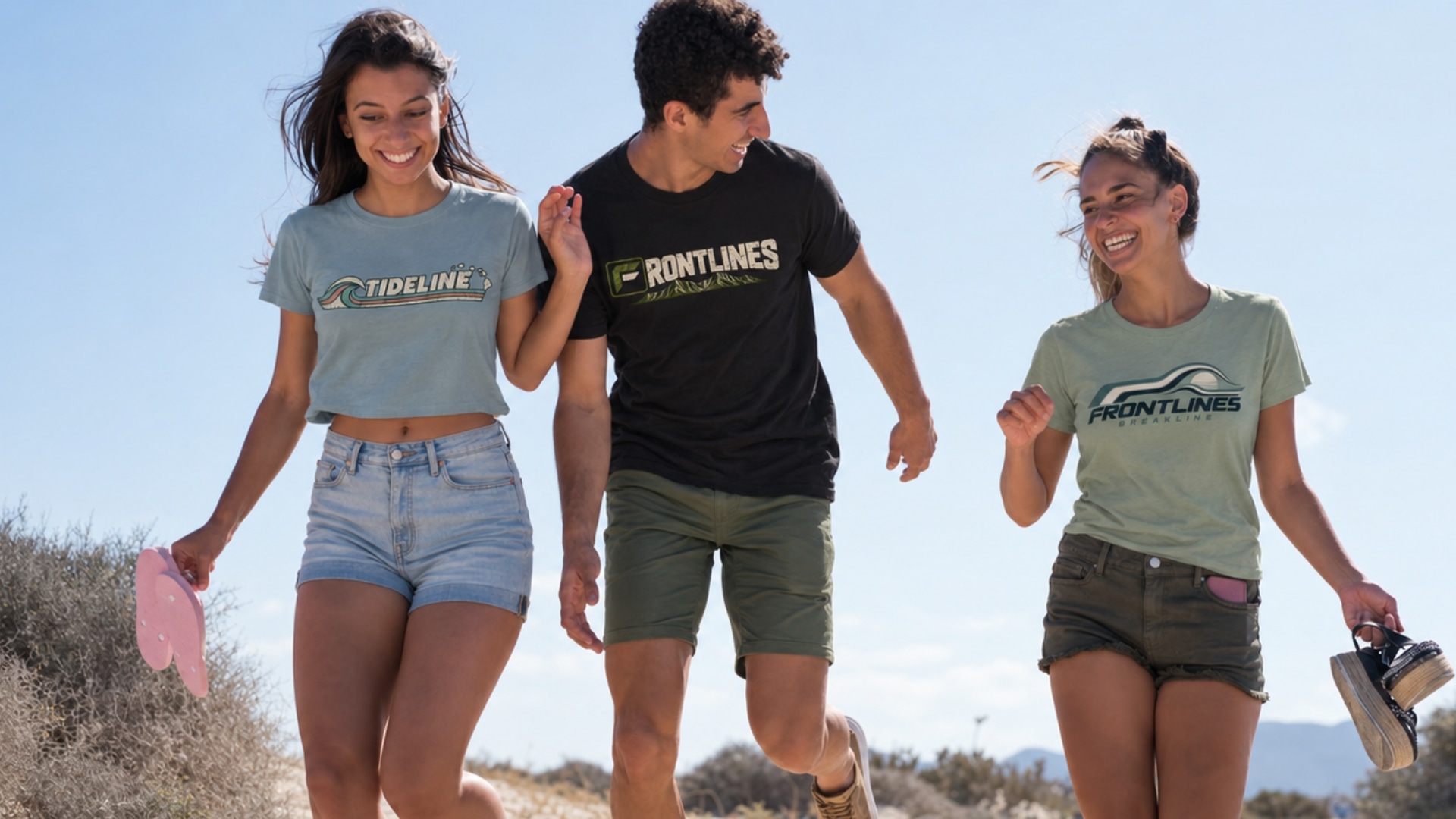 Three people wearing Frontlines, Tideline, and Breakline tees running along the beach