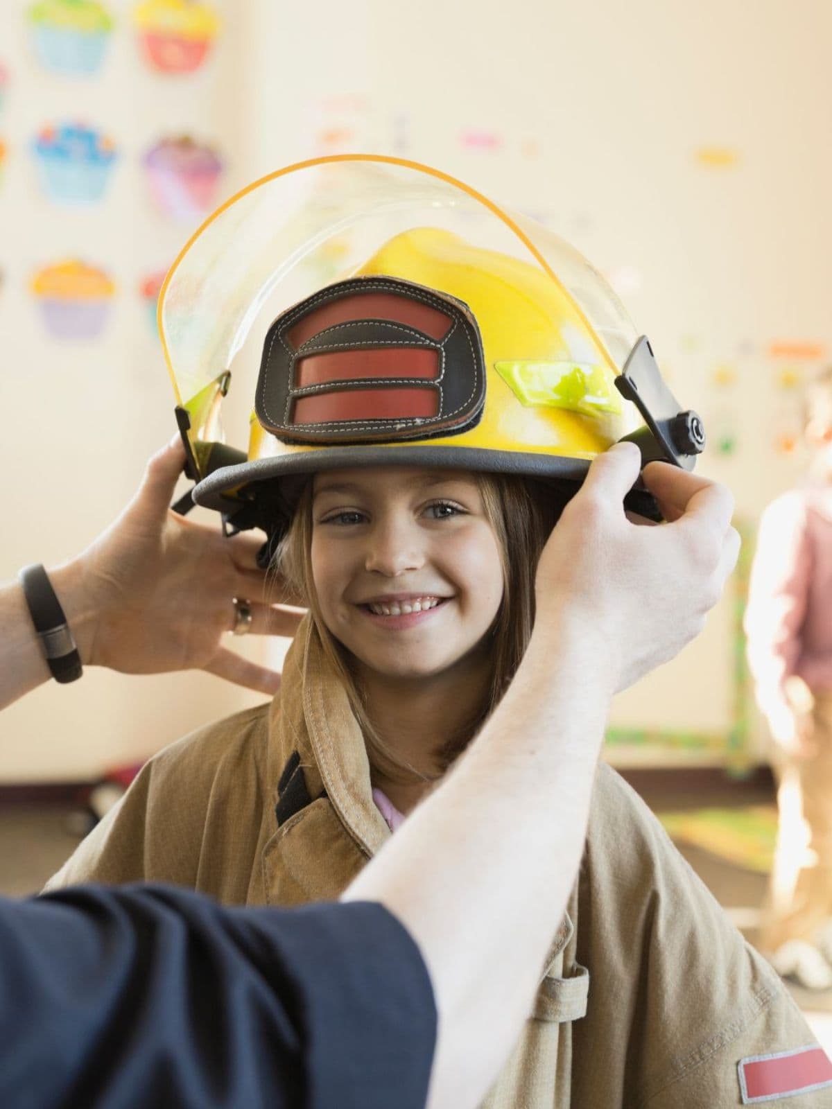 Young future responder trying on firefighter gear
